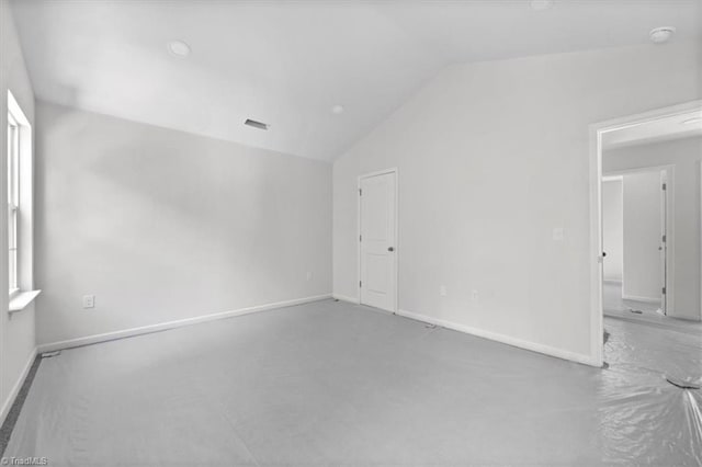 2154 E First St, Winston-Salem, NC 27101 - spare room featuring lofted ceiling, baseboards, carpet flooring, and a smoke detector