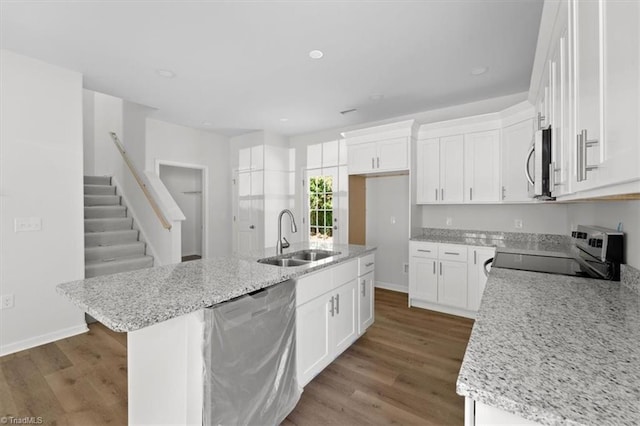 2154 E First St, Winston-Salem, NC 27101 - kitchen with stainless steel appliances, a sink, wood finished floors, white cabinets, and recessed lighting