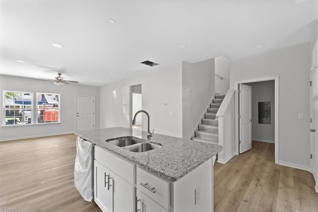 2154 E First St, Winston-Salem, NC 27101 - kitchen with a sink, open floor plan, a ceiling fan, a kitchen island with sink, and light wood-style floors
