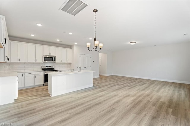 5756 Siler St, Trinity, NC 27370 - kitchen featuring stainless steel appliances, backsplash, light wood-style floors, a chandelier, and light countertops