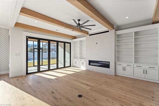 unfurnished living room with beamed ceiling, built in shelves, a fireplace, light wood finished floors, and baseboards