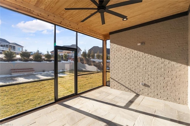 unfurnished sunroom with wooden ceiling and ceiling fan