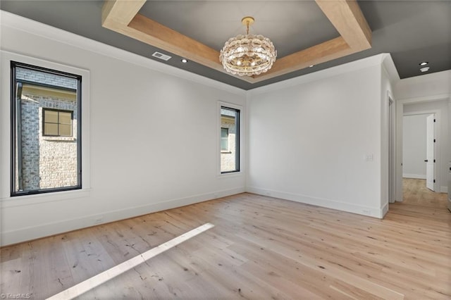 unfurnished room featuring wood finished floors, visible vents, baseboards, a tray ceiling, and a chandelier