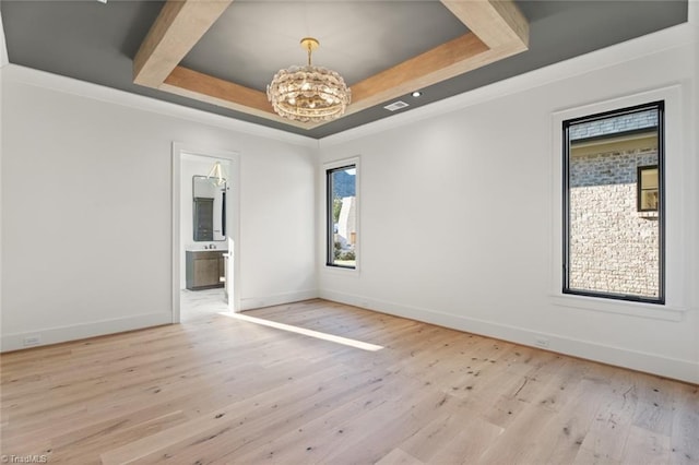 spare room with a tray ceiling, baseboards, a chandelier, and hardwood / wood-style flooring