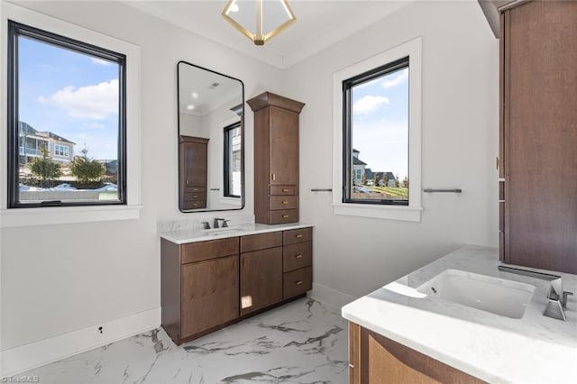 bathroom with vanity, baseboards, and marble finish floor