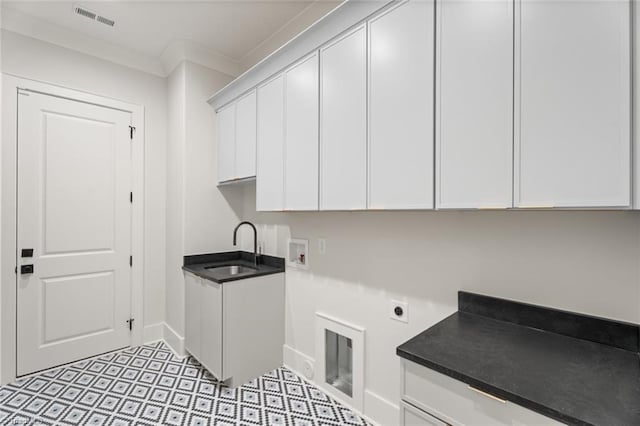 laundry area featuring visible vents, ornamental molding, cabinet space, electric dryer hookup, and a sink