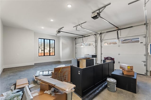 garage with recessed lighting, baseboards, and a garage door opener