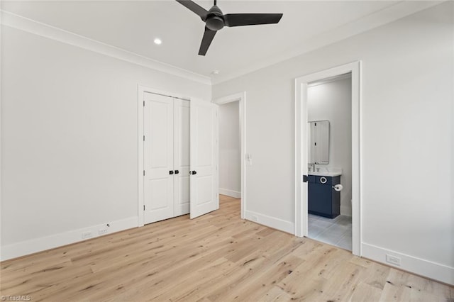 unfurnished bedroom with ensuite bathroom, baseboards, light wood finished floors, and ornamental molding