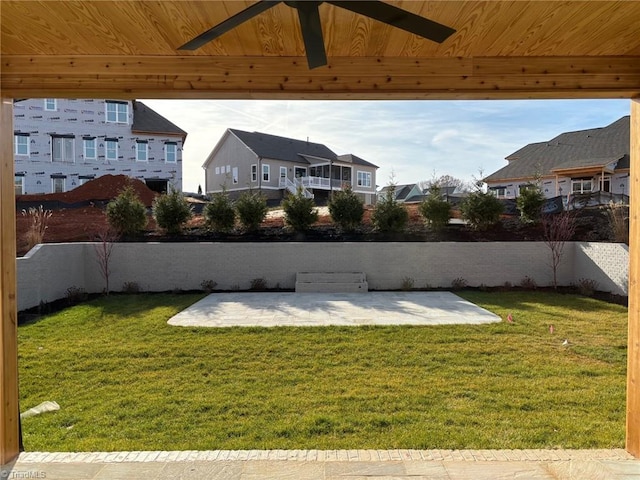 view of yard with fence, a patio area, and a residential view