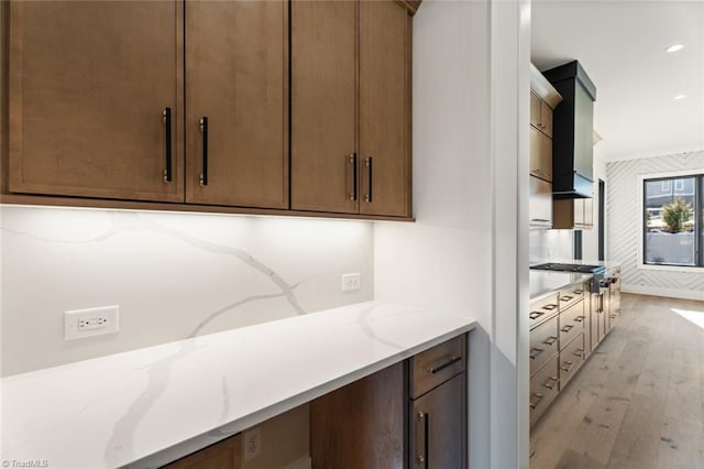 kitchen with light stone counters and light wood-style floors