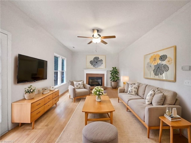 living room with light hardwood / wood-style floors and ceiling fan