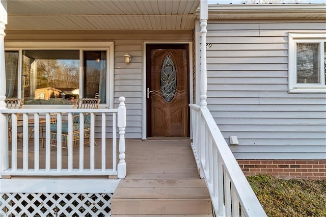 entrance to property featuring a porch