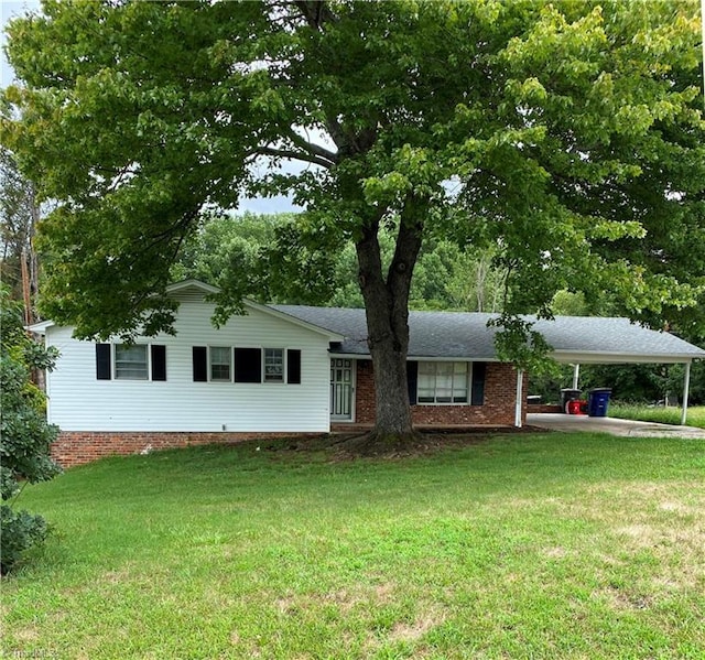 ranch-style home with a carport and a front yard