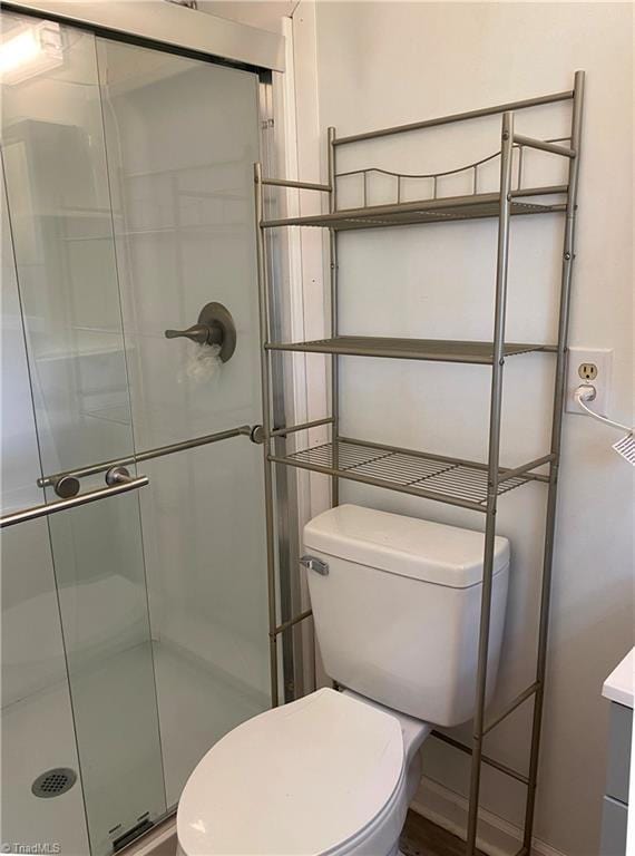 bathroom with walk in shower and toilet