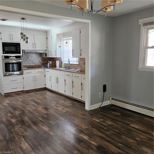 kitchen featuring dark hardwood / wood-style flooring, black microwave, baseboard heating, oven, and white cabinetry