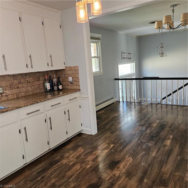 kitchen featuring white cabinets, a baseboard radiator, hanging light fixtures, and dark wood-type flooring