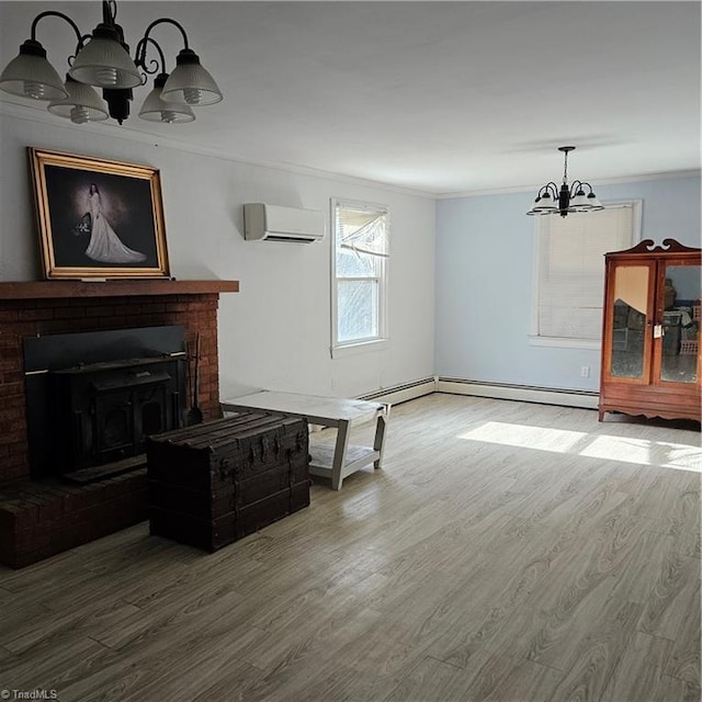 living room featuring hardwood / wood-style floors, an inviting chandelier, a wall mounted AC, and crown molding