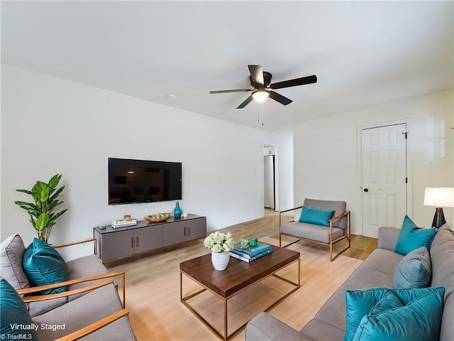 living area featuring ceiling fan and light wood finished floors