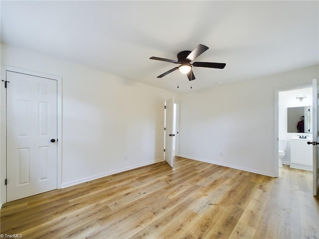 spare room featuring baseboards, light wood-style flooring, and a ceiling fan