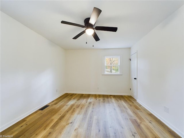 empty room featuring visible vents, baseboards, light wood-style floors, and a ceiling fan