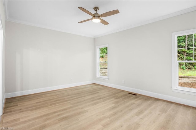 empty room featuring ornamental molding, light hardwood / wood-style floors, and ceiling fan