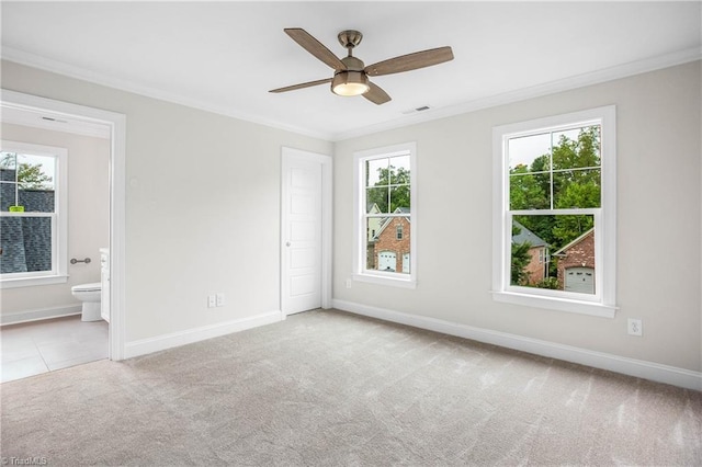 carpeted empty room with ornamental molding and ceiling fan