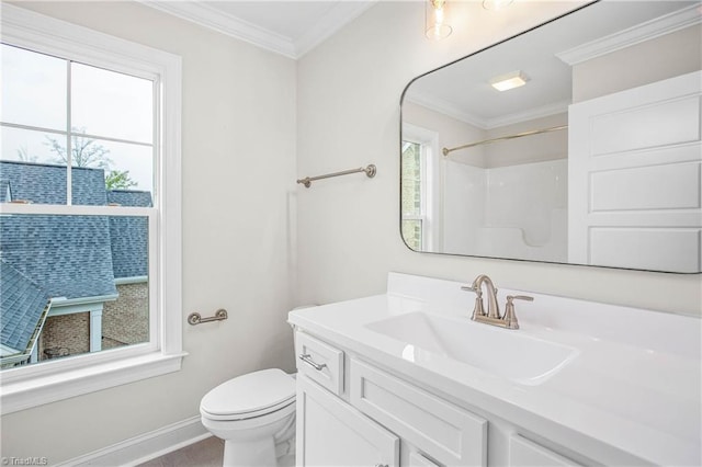 bathroom featuring ornamental molding, plenty of natural light, vanity, and toilet