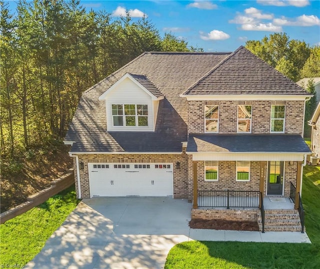 view of front of house featuring a garage and a porch