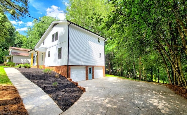 1628 Eagle Crest Dr, Pfafftown, NC 27040 - view of home's exterior with an attached garage, driveway, and brick siding