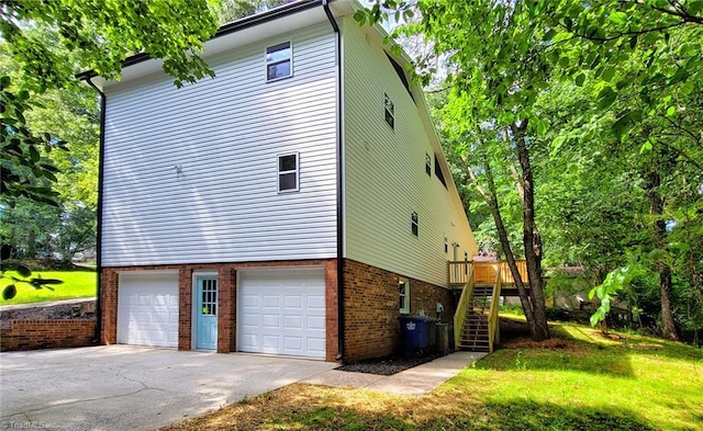 1628 Eagle Crest Dr, Pfafftown, NC 27040 - view of side of home featuring brick siding, a garage, stairway, driveway, and a wooden deck