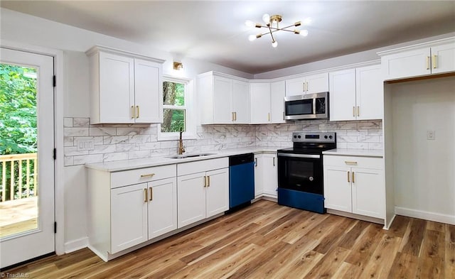 1628 Eagle Crest Dr, Pfafftown, NC 27040 - kitchen with stainless steel microwave, electric range, dishwashing machine, light countertops, and white cabinets
