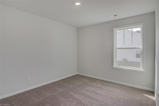 empty room with carpet, visible vents, baseboards, and recessed lighting