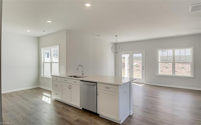 kitchen with a sink, visible vents, open floor plan, dishwasher, and plenty of natural light