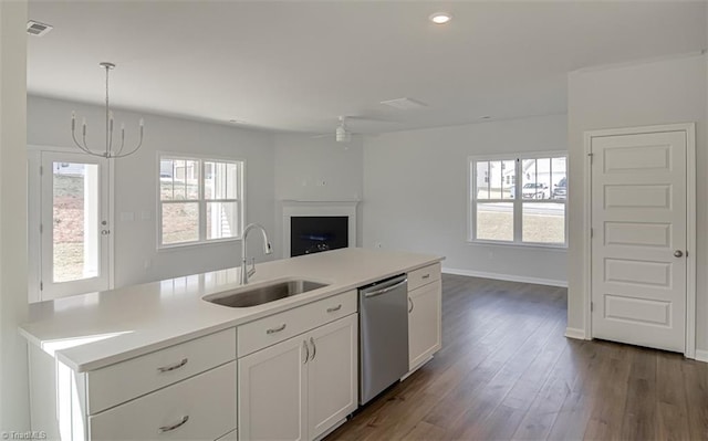 kitchen featuring dishwasher, dark wood-style floors, light countertops, white cabinetry, and a sink