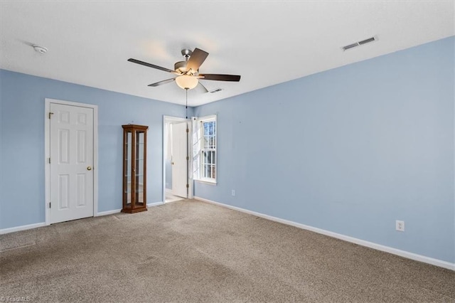 unfurnished bedroom with a ceiling fan, baseboards, visible vents, and carpet flooring