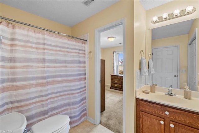 bathroom featuring baseboards, visible vents, toilet, curtained shower, and vanity