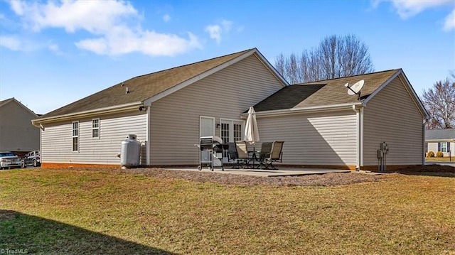 back of property with a patio and a lawn