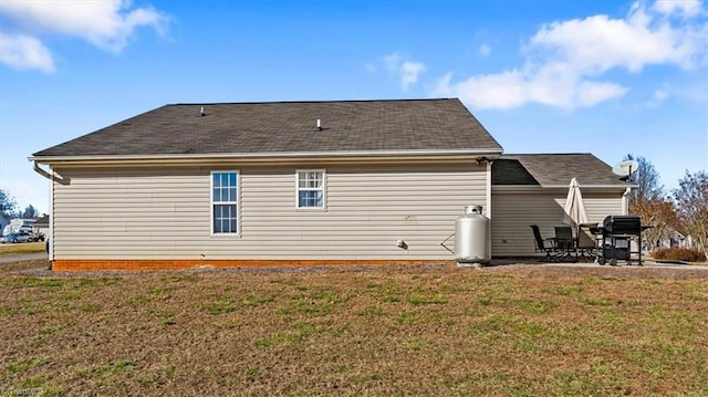 rear view of property featuring a patio area and a yard