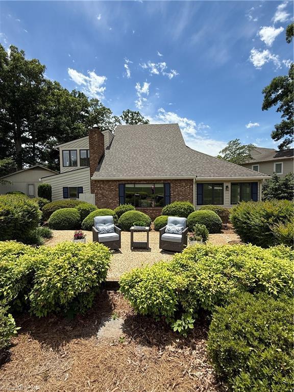 191 Fairway Dr, Advance, NC 27006 - view of front facade with a chimney, roof with shingles, and brick siding