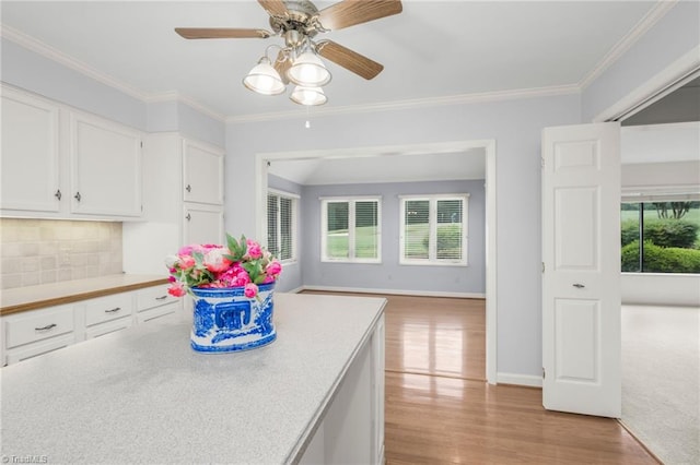 191 Fairway Dr, Advance, NC 27006 - kitchen with white cabinetry, light wood finished floors, light countertops, backsplash, and crown molding