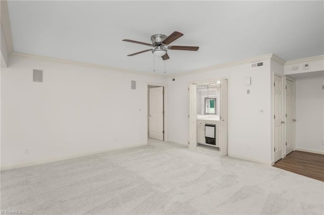 191 Fairway Dr, Advance, NC 27006 - spare room with ceiling fan, crown molding, baseboards, and light carpet