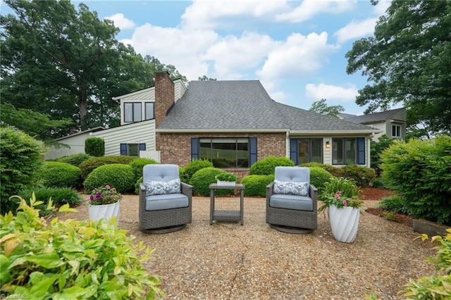 191 Fairway Dr, Advance, NC 27006 - back of property with a chimney, brick siding, and a shingled roof