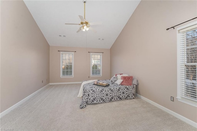 carpeted bedroom featuring ceiling fan, visible vents, baseboards, and vaulted ceiling