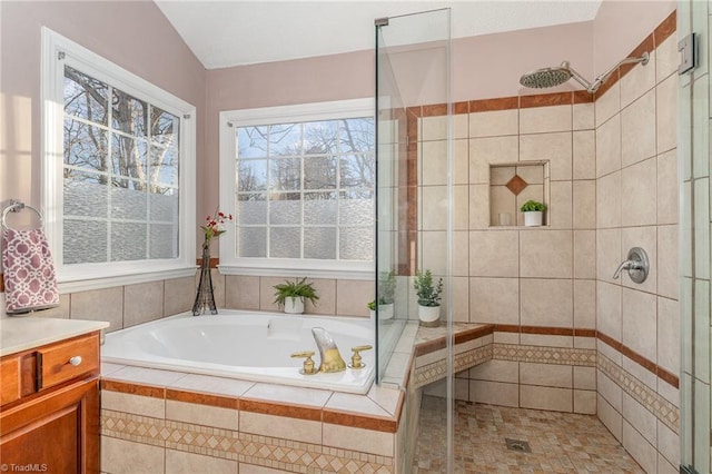 full bathroom featuring a garden tub, a shower stall, and vanity