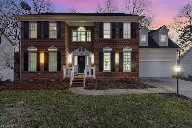 view of front of property with brick siding, concrete driveway, an attached garage, a front yard, and crawl space