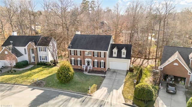 view of front of house featuring concrete driveway and a front yard