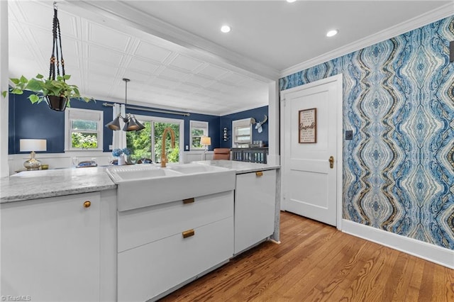 2607 Sherwood St, Greensboro, NC 27403 - kitchen featuring white cabinets, light wood-style flooring, crown molding, decorative light fixtures, and recessed lighting