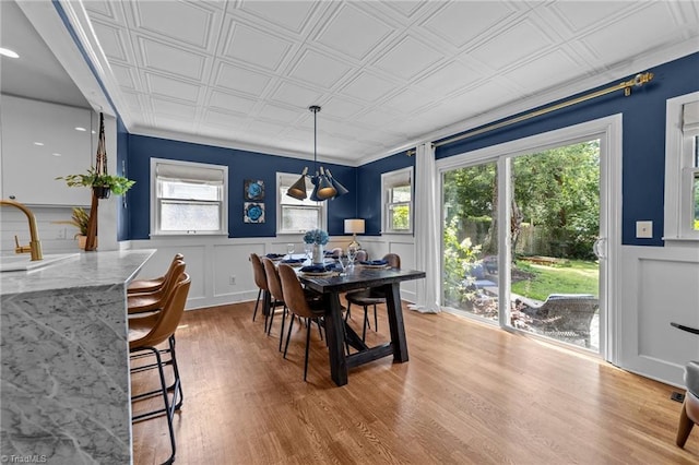 2607 Sherwood St, Greensboro, NC 27403 - dining space featuring an ornate ceiling, healthy amount of natural light, wood finished floors, and wainscoting