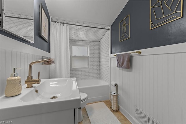 2607 Sherwood St, Greensboro, NC 27403 - full bathroom with vanity, a wainscoted wall, and tile patterned floors