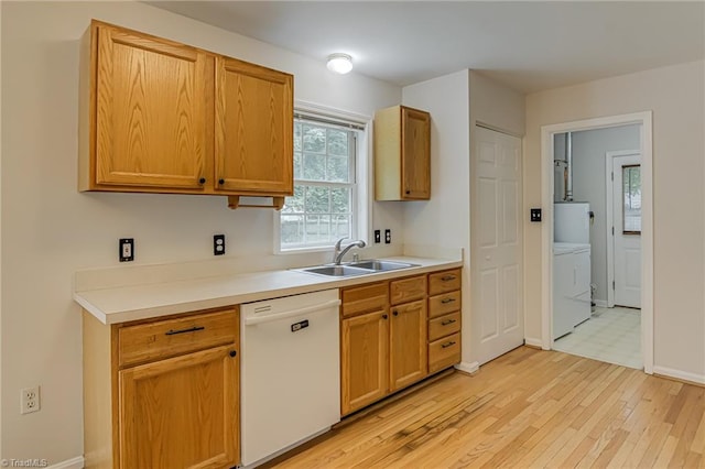 5201 Harvey Rd, Jamestown, NC 27282 - kitchen featuring white dishwasher, washing machine and dryer, light wood finished floors, and light countertops